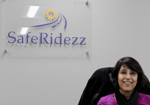 Smiling Saferidezz dispatcher working in the office.
